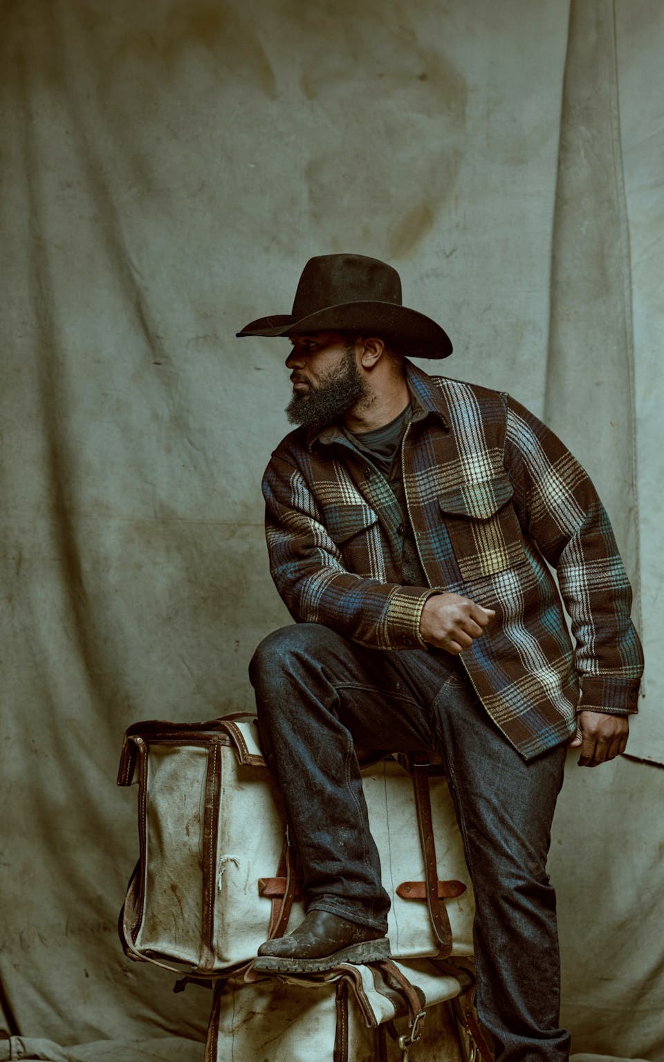 Man in Filson plaid Jac-Shirt standing in front of backdrop