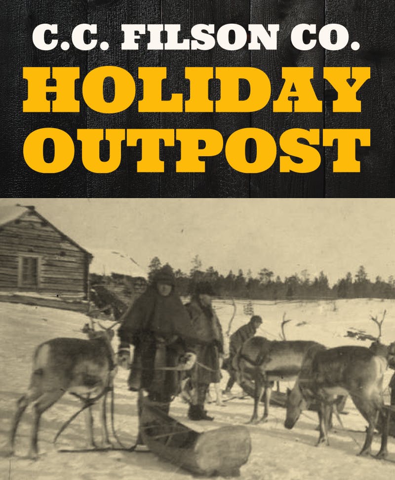 Men with caribou/elk and sleds, standing outside in the snow