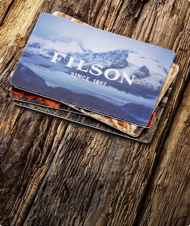 Woman wearing Filson gear with mountains in the backdrop
