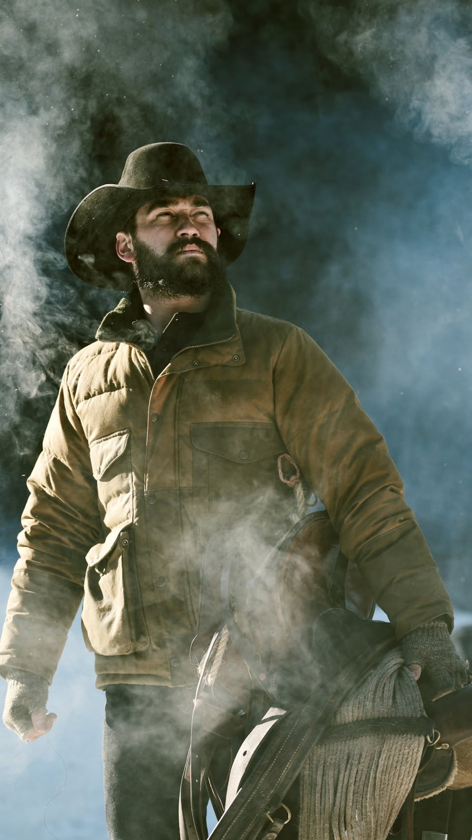 men riding horses wearing filson outerwear